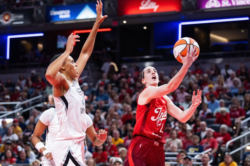 Aug 6, 2026; Indianapolis, Indiana, USA;  Indiana Fever guard Caitlin Clark (22) shoots the ball against Las Vegas Aces forward Brianna Turner (21) in the first half at Gainbridge Fieldhouse. Mandatory Credit: Trevor Ruszkowski-Imagn Images