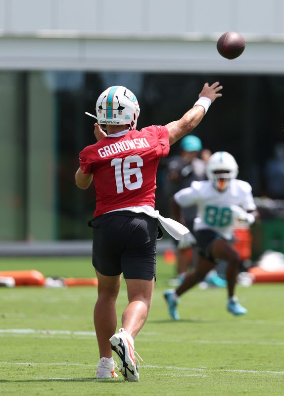 Jun 2, 2026; Miami Gardens, FL, USA; Miami Dolphins quarterback Mark Gronowski (16) throws a ball to wide receiver AJ Henning (88) during mini camp at Baptist Health Training Complex. Mandatory Credit: Isabella Frias-Imagn Images