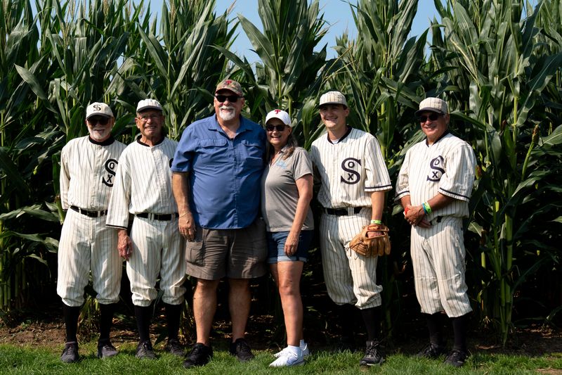 Dawn Warren and Michael Janzer take a photo with the Ghost Players Aug. 11, 2026 at the Field of Dreams in Dyersville, Iowa.