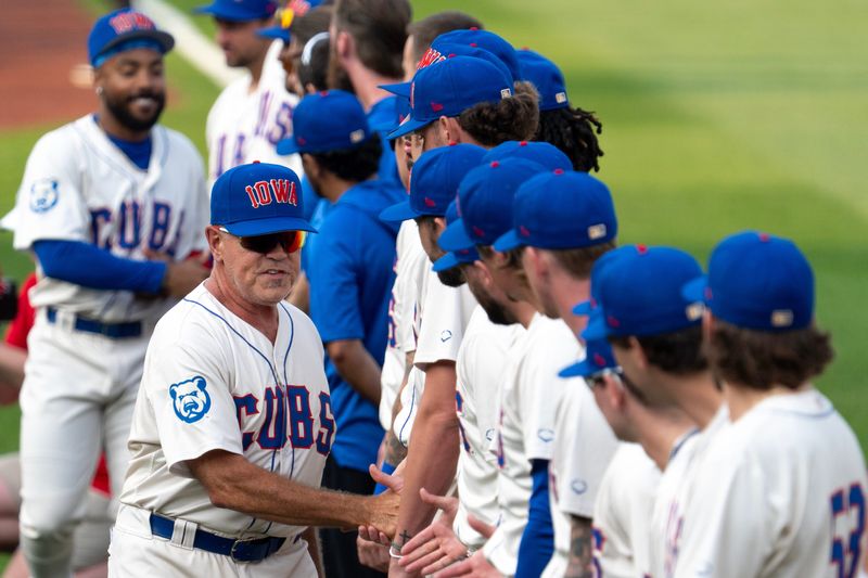 Iowa Cubs manager Marty Pevey high-fives the team during lineup introductions for a minor league baseball game against the St. Paul Saints Aug. 11, 2026 at the Field of Dreams in Dyersville, Iowa.