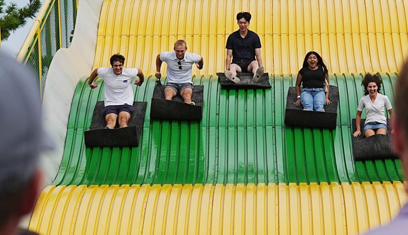 Fairgoers slide down the giant slide at the Iowa State Fair on Aug. 13, 2026, in Des Moines.