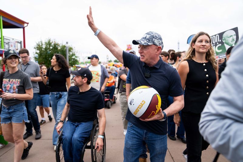 U.S. Sen. Mark Kelly, D-AZ, tours the Iowa State Fairgrounds with Democratic U.S. Senate candidate Josh Turek on Aug. 14, 2026.