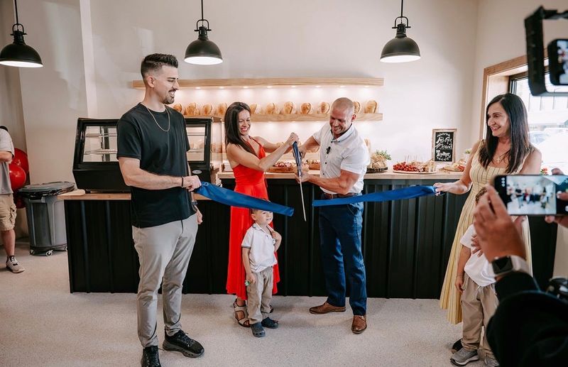 Nina and Mike Harris cut the ribbon at their new sourdough bread bakery, Home Kneads, in downtown Slater.