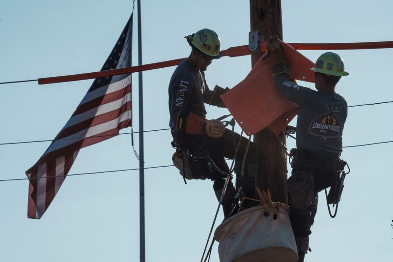 Competitors climb a pole during the Iowa Utility Association Lineman Rodeo at the Iowa State Fair Aug. 21, 2026.