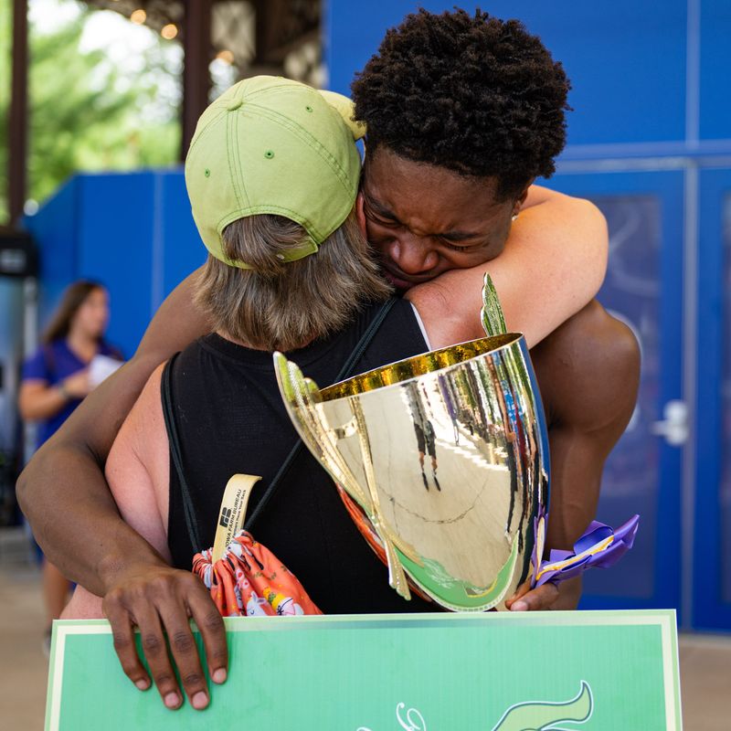Caleb Meiners, 20, of Ottumwa, embraces Karen Adams, talent coordinator at the Southern Iowa Fair, after winning first place at the Bill Riley Talent Search finals at the Iowa State Fair on Aug. 23, 2026.