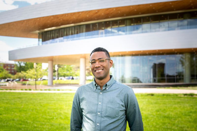 Andre Perry, executive director of Hancher Auditorium, poses for a photo, Monday, May 16, 2022, on the Hancher Green in Iowa City, Iowa.
