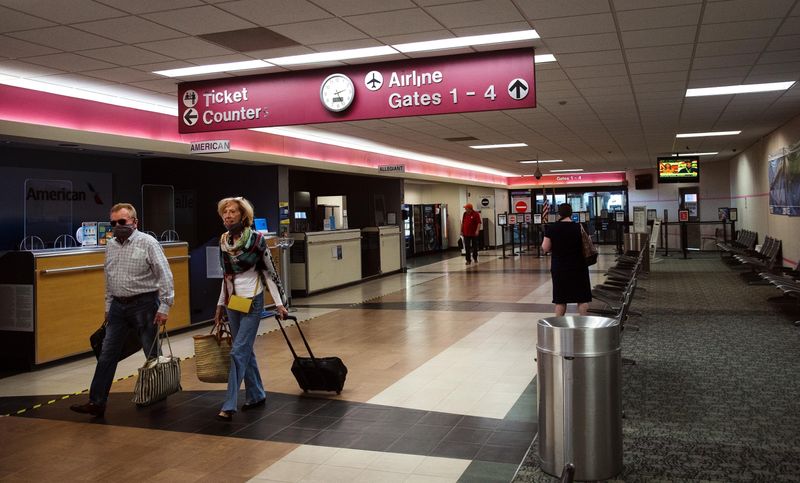 Passengers from a returning American Airlines flight make their way through the terminal at Abraham Lincoln Capital Airport Friday, June 5, 2020.