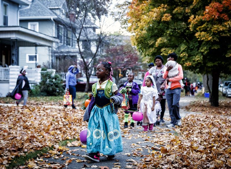 Aniya Sims made her way down the sidewalk for the next stop as Anna from Frozen during Halloween trick-or-treating on the 1500 block of Holmes Avenue, in Springfield, Ill.