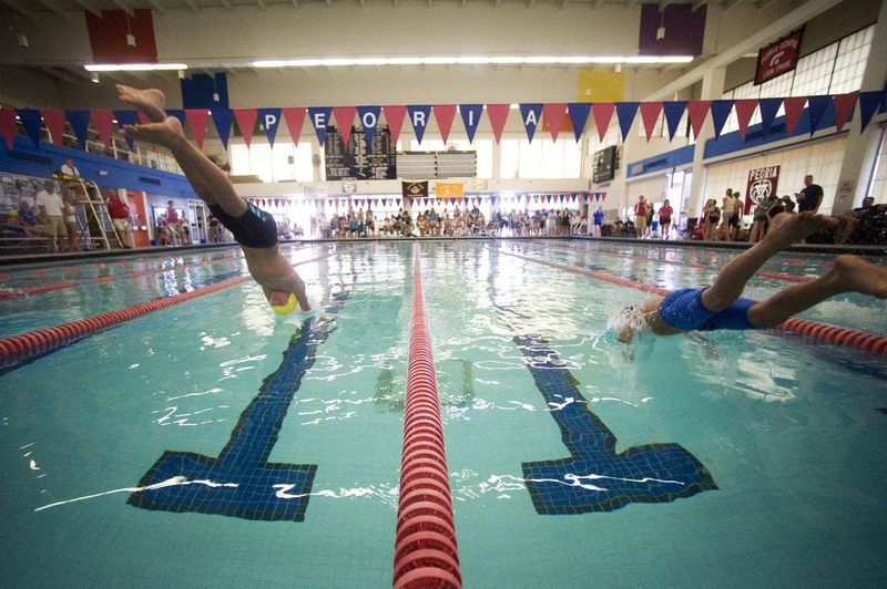 Swimmers jump into the water at the sound of the start for the 50-yard butterfly at the Journal Star swim meet at Central Park pool.