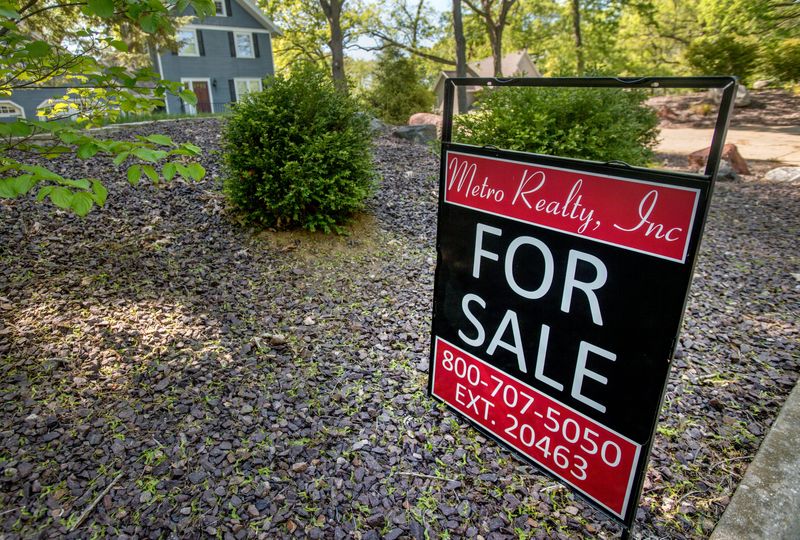 A “For Sale” sign is planted on the curb outside a house for sale on Grandview Drive in Peoria.