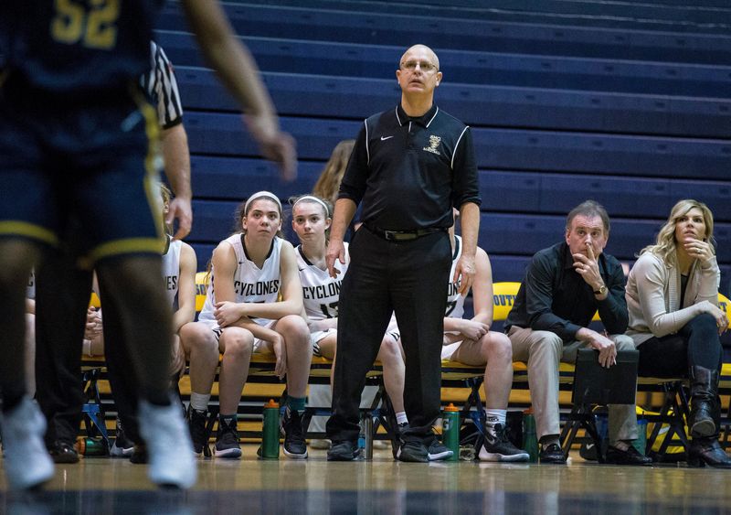 Mike Gaffney (seated, second from the right) looks on while Steve Klunick studies the City Tournament basketball game between Sacred Heart-Griffin and Southeast in 2016. Gaffney has been hired as the SHG girls head coach.