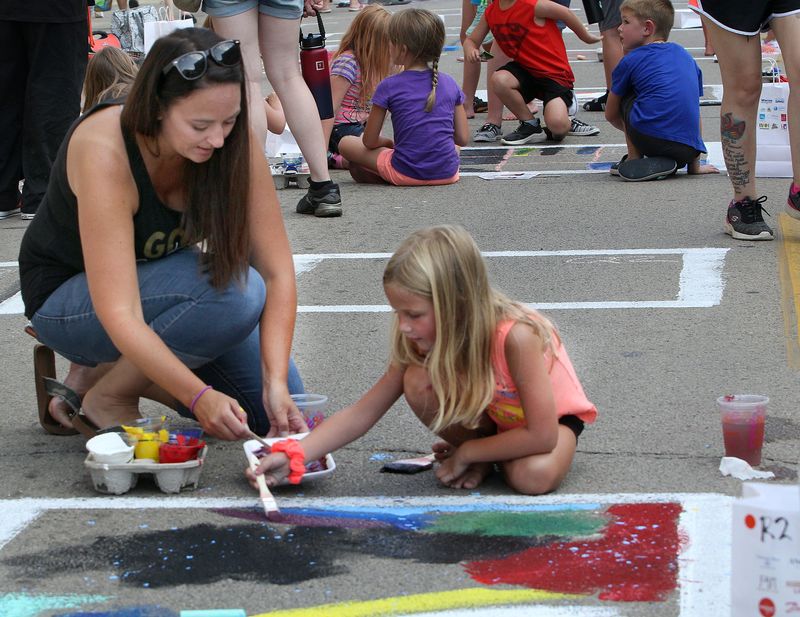 Stephanie Moore, left, helps her daughter Kayleigh Moore paint a square as the duo participated in Paint the Port on Friday, Aug. 27, 2021, in downtown Freeport.