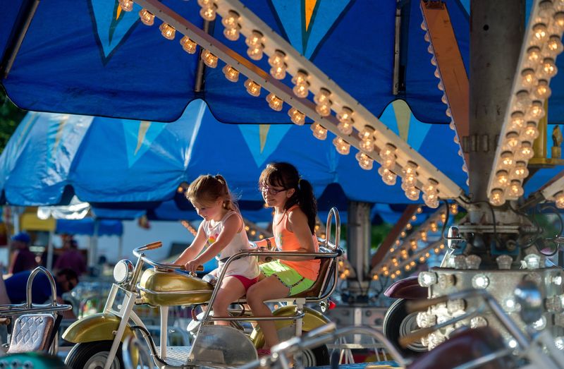 Allie Huenefeld, 4, right, and Nilah Jeffries, 8, both of Chillicothe, take a spin on the motorcycles carnival ride during Claud-Elen Days on June 7, 2019 in Chillicothe.