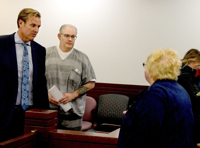 Peter Cadigan, center, stands next to his lawyer, Justin Kuehn, left, as he talks to his mother Mary Cadigan, after his successful pre-trial release motion Monday, Oct. 30, 2023. Cadigan pleaded guilty to involuntary manslaughter in the Earl Moore Jr. murder case on April 24, 2026.
