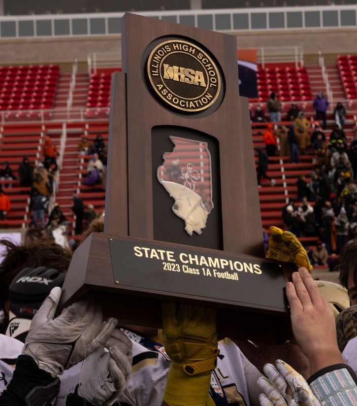 The Camp Point Central Panthers lift their trophy after winning the IHSA 1A football state final on Nov. 24, 2023 at Hancock Stadium at Illinois State University.