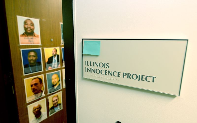 A sign outside the office of the Illinois Innocence Project office at the University of Illinois Springfield is seen on March 27, 2024, with photos of some of their clients who were exonerated.