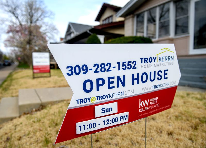 An "Open House" sign stands in the front yard of a house for sale on W. Hanssler Place in Peoria.