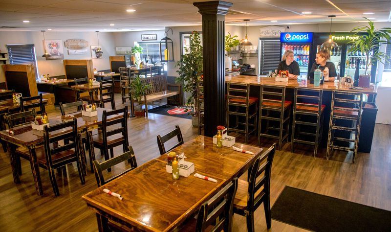 Owners Tina and Kyle Kraft refinished every table and chair in their restaurant The Farmstead in Roanoke. The restaurant offers a small bar in addition to meals.