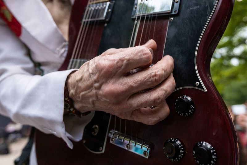 Frank Livingston, founding member of the Led Zeppelin tribute band Kashmir, plays a guitar solo during a concert on Thursday, June 6, 2024, at the Sinnissippi Park Music Shell in Rockford.