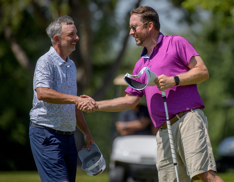 Rod Jackson, left, congratulates Scott Phegley on his victory in the 98th Peoria Men's City golf championship Saturday, Aug. 3, 2024 at Kellogg Golf Course in Peoria. This is the fourth title, and second consecutive, for Phegley, a Morton High School and Bradley University alum.