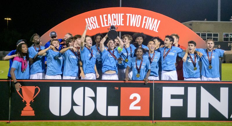 The Seacoast United Phantoms raise their trophy after defeating Peoria City 3-2 in overtime of the USL2 national championship match Saturday, Aug. 3, 2024 at Shea Stadium in Peoria.