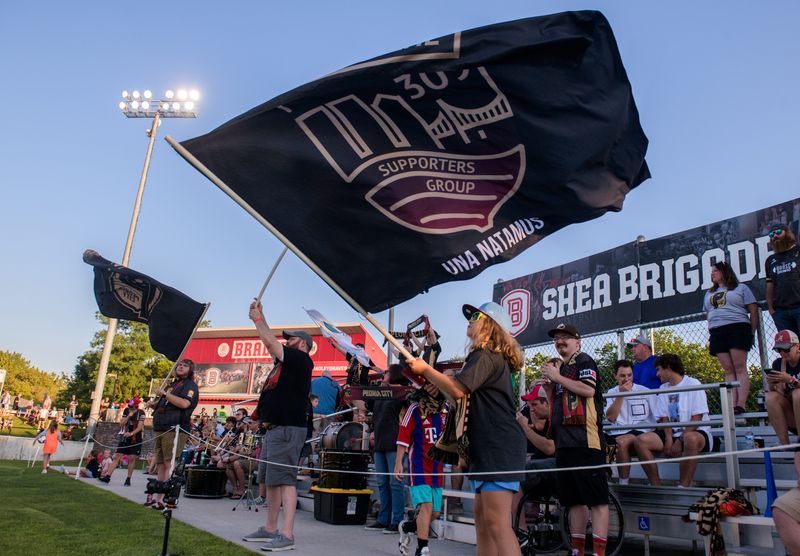 Fans in The 309 soccer fan group wave their flags before the start of the USL2 national championship match Saturday, Aug. 3, 2024 at Shea Stadium in Peoria. Peoria City fell to the Seacoast United Phantoms 3-2.