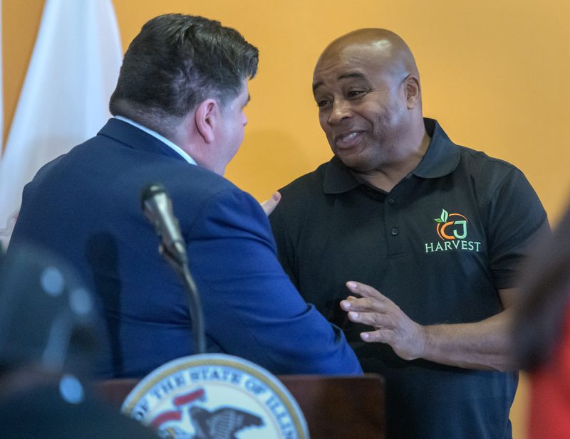 Chuck Brown, proprietor of the CJ Harvest Supermarket currently under development in South Peoria, shakes hands with Illinois Gov. JB Pritzker after a press conference Thursday, Oct. 3, 2024 at the store at 210 S. Western Avenue. The business has received more than $1.6 million from a state initiative to eliminate food deserts in the state.