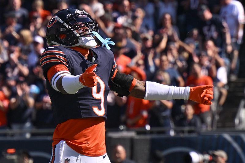 Oct 6, 2024; Chicago, Illinois, USA; Chicago Bears safety Jaquan Brisker (9) celebrates a defensive stop against the Carolina Panthers during the first quarter at Soldier Field. Mandatory Credit: Daniel Bartel-Imagn Images