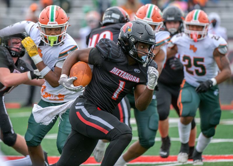 Metamora’s Jaiduan Cranford finds a hole in the Morgan Park defense for a touchdown run in the first half of their second-round football playoff game Saturday, Nov. 9, 2024 in Metamora. The Redbirds were eliminated 55-28.