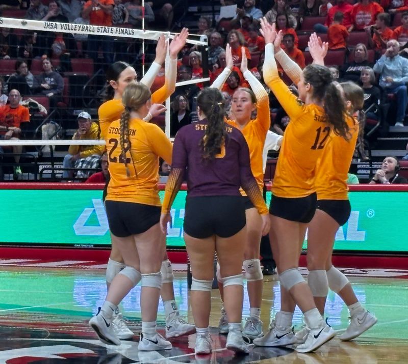 Stockton players celebrate winning a point in their Class 1A state girls volleyball semifinal victory Friday, Nov. 15, 2024 at CEFCU Arena in Normal, Ill.