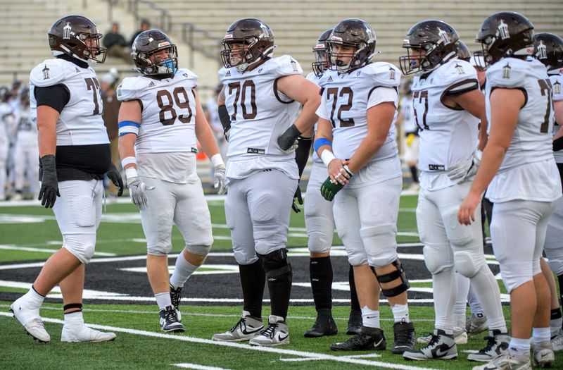 The Joliet Catholic offensive line gathers on the field before a play against Peoria High in the second half of their Class 5A state quarterfinal football game Saturday, Nov. 16, 2024 at Peoria Stadium. The Lions fell to the Hilltoppers 43-8.