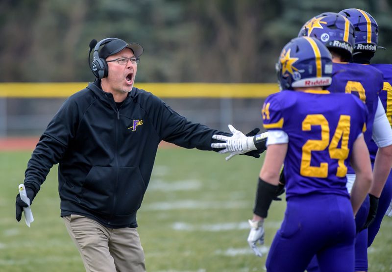 Farmington head coach Toby Vallas encourages his team as they battle Chicago Christian in the first half of their Class 2A state football semifinal game Saturday, Nov. 23, 2024 in Farmington. The Farmers fell 34-20.