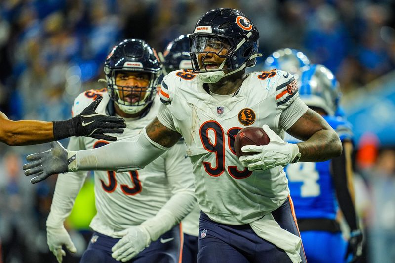 Chicago Bears defensive tackle Gervon Dexter Sr. (99) celebrates recovering the fumble made by Detroit Lions running back Jahmyr Gibbs (26) on Thanksgiving Day at Ford Field in Detroit on Thursday, Nov. 28, 2024.