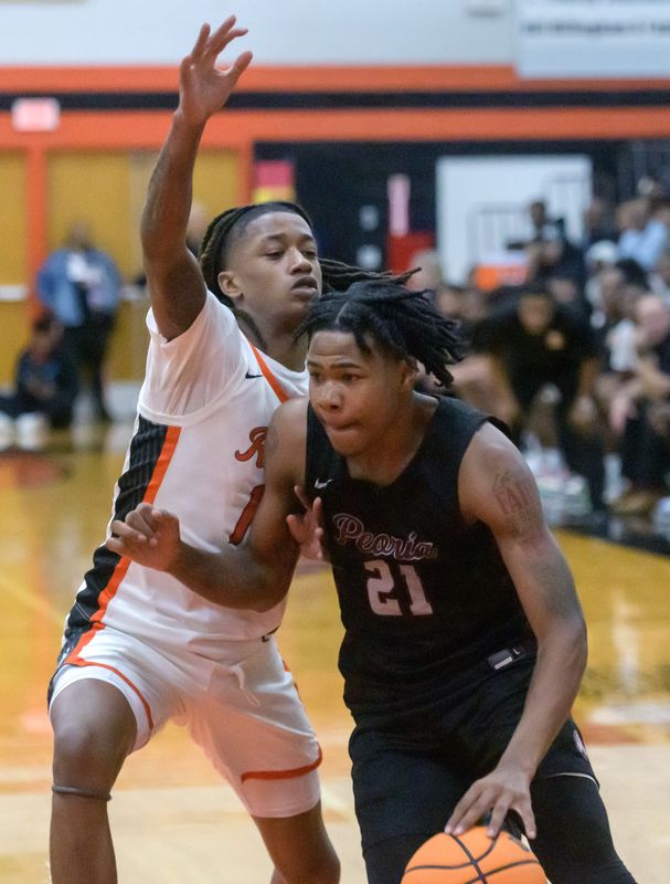 Manual’s Dietrich Richardson, left, guards Peoria High’s Leshawn Stowers in the second half of their high school basketball game Friday, Jan. 3, 2025 at Manual High School. The Rams defeated the Lions 47-43.