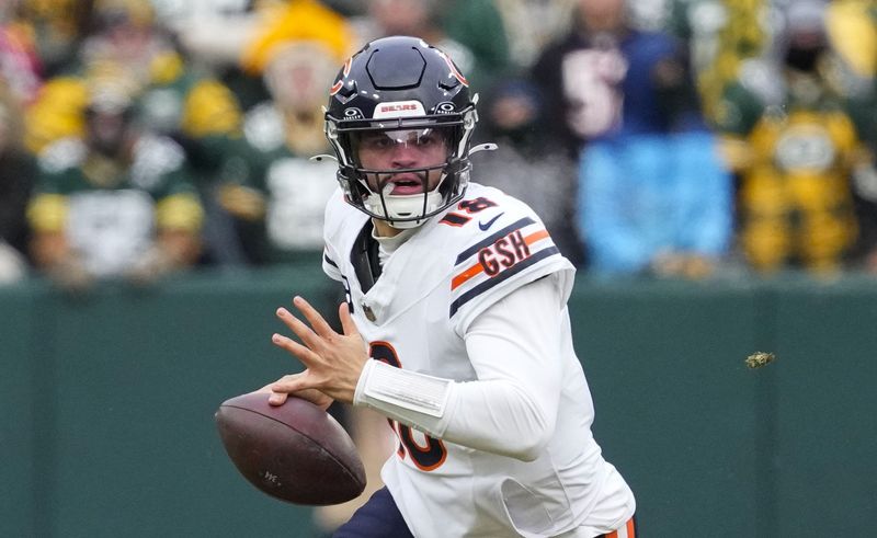 Jan 5, 2025; Green Bay, Wisconsin, USA; Chicago Bears quarterback Caleb Williams rushes with the football during the second quarter against the Green Bay Packers at Lambeau Field. Mandatory Credit: Jeff Hanisch-Imagn Images