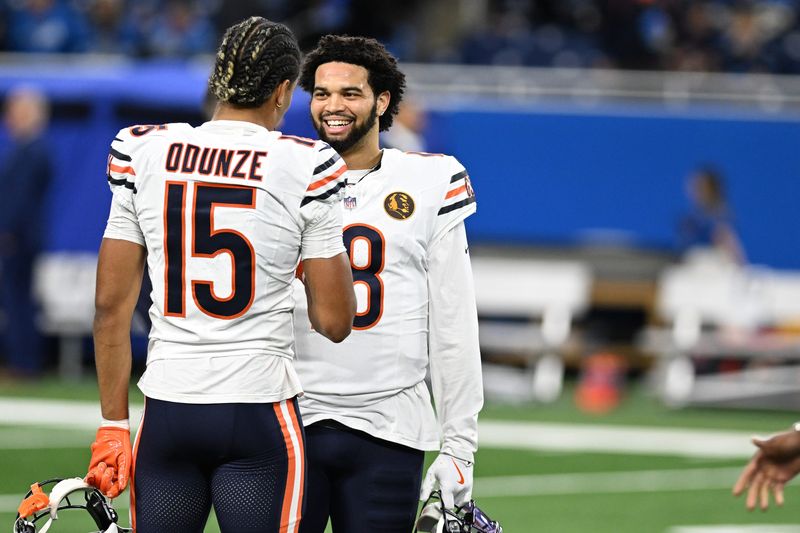 Nov 28, 2024; Detroit, Michigan, USA; Chicago Bears quarterback Caleb Williams (18) greets wide receiver Rome Odunze (15) during pregame warmups before their game against the Detroit Lions at Ford Field. Mandatory Credit: Lon Horwedel-Imagn Images