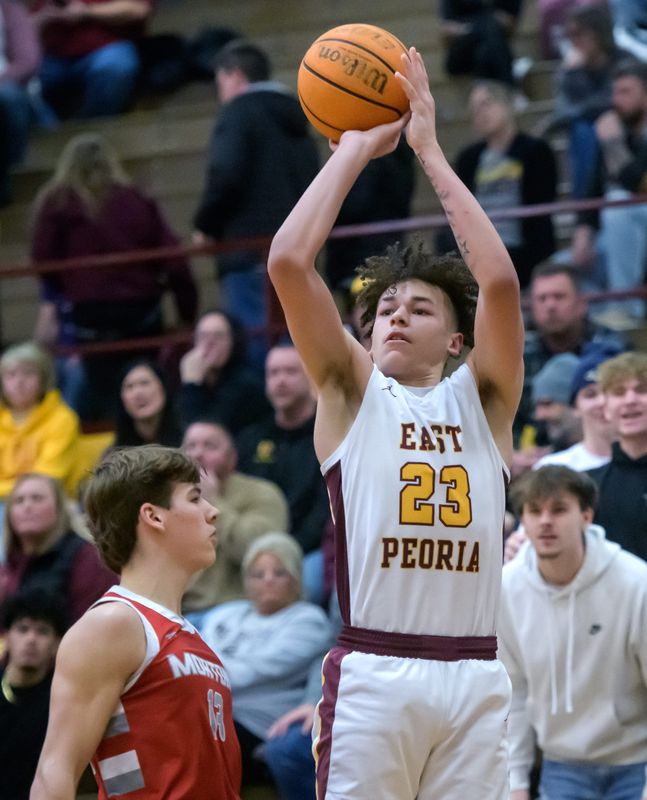 East Peoria’s Quinton Kitt puts up a three-pointer against Morton in the second half of their Mid-Illini high school basketball game Friday, Feb. 8, 2025 at East Peoria High School. The Raiders upset state-ranked Morton 72-69 in overtime.