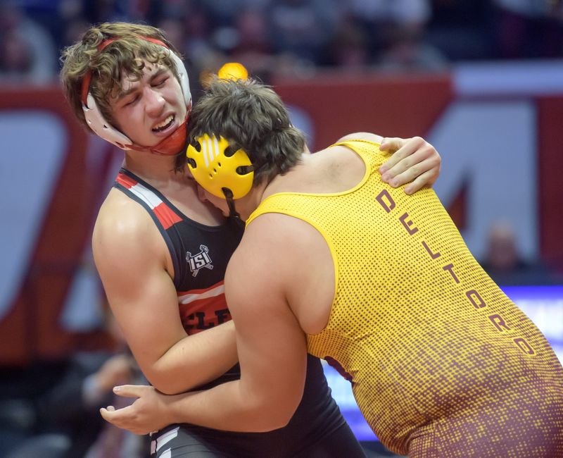 Chatham Glenwood's Cody Moss, left, battles East Peoria's Jose Del Toro in the 285-pound match of the Class 2A state high school wrestling championships Saturday, Feb. 22, 2025 at the State Farm Center in Champaign. Moss took the title with a 9-7 decision.