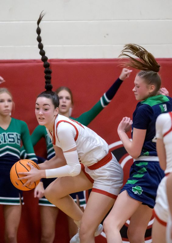 Dee-Mack’s Dalia DeJesus, left, comes down with a rebound against Peoria Notre Dame’s Cora Heinz in the second half of the Class 2A Dee-Mack Sectional title game Thursday, Feb. 27, 2025 in Mackinaw. The Irish took the title 47-43.