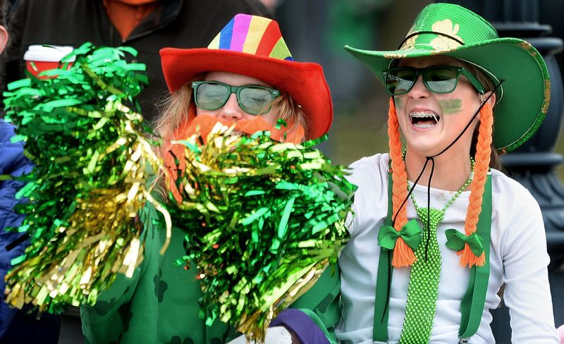 Aurora Holmes, 13, left, and Fayth Sockolis, 13, both of Athens, cheer during the Saint Patrick's Day parade on March 15, 2025, in Springfield.