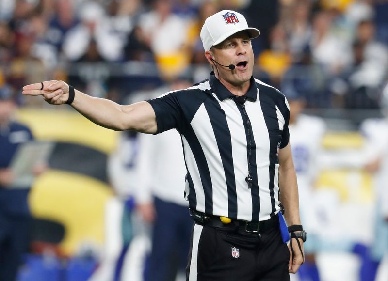 Oct 6, 2024; Pittsburgh, Pennsylvania, USA; NFL referee Shawn Hochuli (83) signals a penalty on the Dallas Cowboys against the Pittsburgh Steelers during the third quarter at Acrisure Stadium. Mandatory Credit: Charles LeClaire-Imagn Images