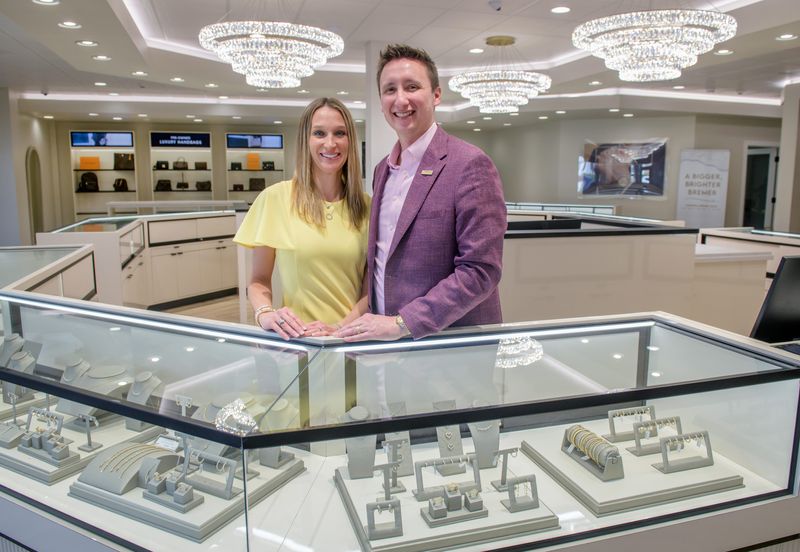 Justin and Julie May stand behind the counter in the newly renovated and expanded Bremer Jewelry at 4707 N. University Street in Peoria. They have owned the business since 2022.