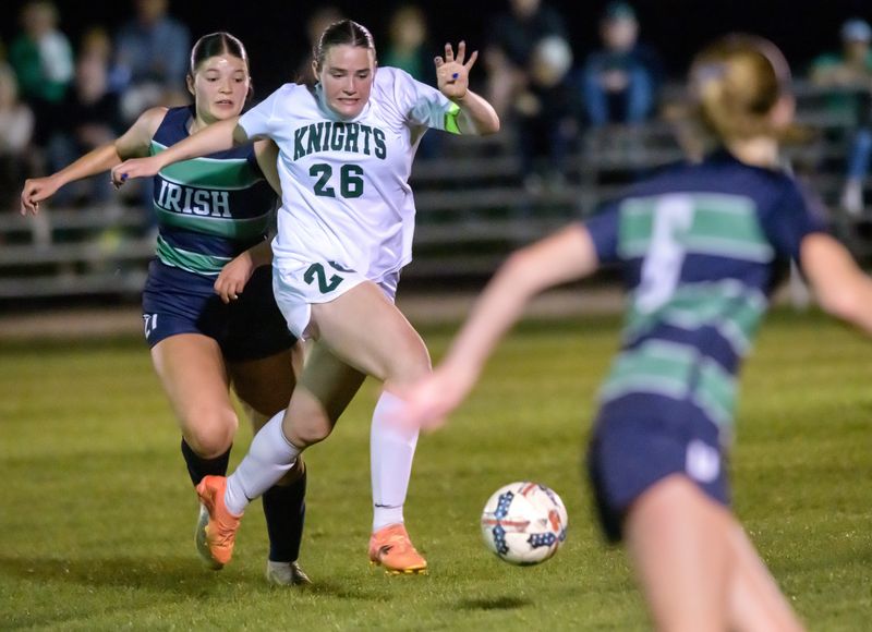 Richwoods’ Sadie McMorris (26) moves the ball through the Peoria Notre Dame defense in the second half of their girls high school soccer match Wednesday, April 23, 2025 at PND High School. The match ended in a scoreless tie.