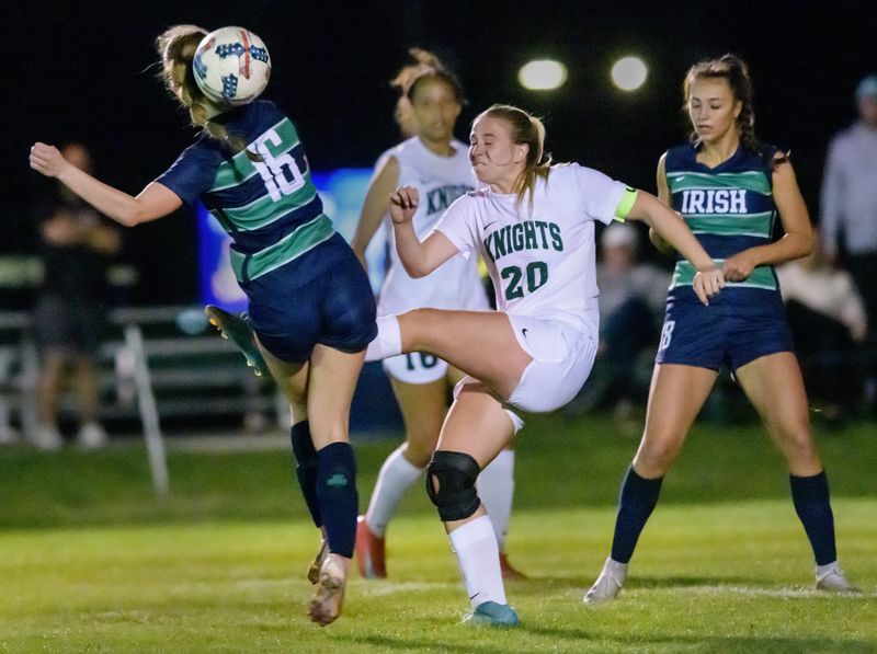 Richwoods’ Abby Cooley (20) tries to clear the ball as Peoria Notre Dame’s Abigail Chaddock (16) defends in the second half of their girls high school soccer match Wednesday, April 23, 2025 at PND High School. The match ended in a scoreless tie.
