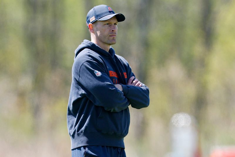 May 9, 2025; Lake Forest, IL, USA; Chicago Bears head coach Ben Johnson (R) looks on during the Rookie Minicamp at Halas Hall. Mandatory Credit: Kamil Krzaczynski-Imagn Images