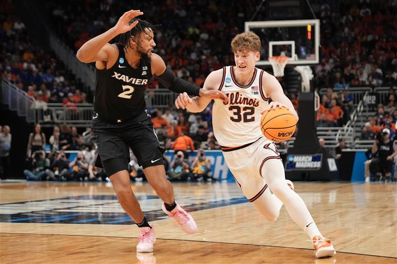 Illinois guard Kasparas Jakucionis (32) drives to the basket against Xavier forward Jerome Hunter (2) in an NCAA Tournament game at Fiserv Forum in Milwaukee, Wisconsin on Friday, March 21, 2025.