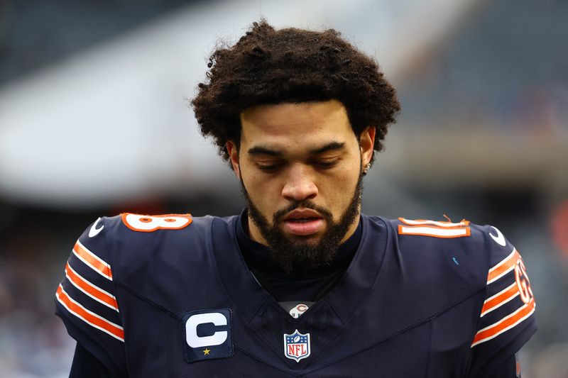 Dec 22, 2024; Chicago, Illinois, USA; Chicago Bears quarterback Caleb Williams (18) walks off the field after the game against the Detroit Lions during the second half at Soldier Field. Mandatory Credit: Mike Dinovo-Imagn Images