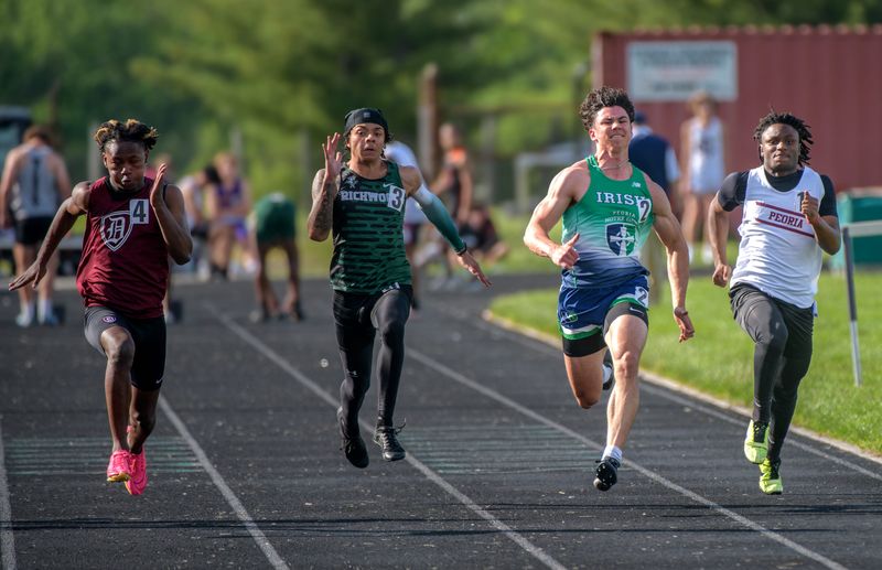 Left to right: Danville's Jayden Rowell outruns Richwoods' Khyree Berry, Peoria Notre Dame's Ben Lutz and Peoria's Detaurion Pollard in Heat 2 of the 100-meter dash during the Big Twelve Boys Track and Field Championships on Wednesday, May 14, 2025 at Richwoods Stadium in Peoria. Rowell won the heat and finished eighth overall, while Lutz was second in the heat and tenth overall. Berry finished 13th and Pollard was 16th.