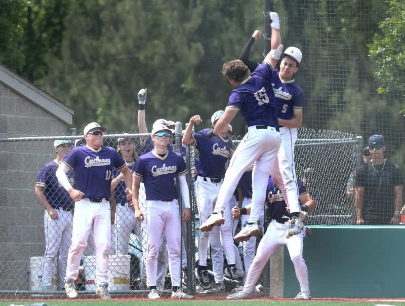Sacred Heart-Griffin's Andy Antonacci, right front, gets a high five from teammate Will Pennell after Antonacci rounded the bases after hitting a home run during Saturday's Class 2A sectional final May 31, 2025.