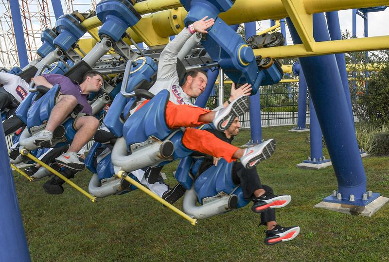 Clemson head coach Dabo Swinney and Iowa State Head Coach Matt Campbell ride a rollercoaster during the Cheez-It Bowl Day for Kids at Fun Spot America theme park in Orlando, Florida Monday, December 27, 2021. A large group of children from a redeveloped neighborhood around the Camping World Stadium in Orlando, Florida were paired up with Clemson and Iowa State players to have a morning of theme park rides. Florida Theme Park Rides